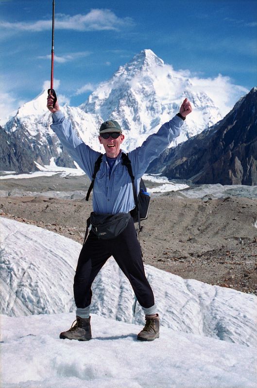 04 Jerome Ryan On Upper Baltoro Glacier With K2 Behind Jerome Ryan poses with K2 behind from the Upper Baltoro Glacier.